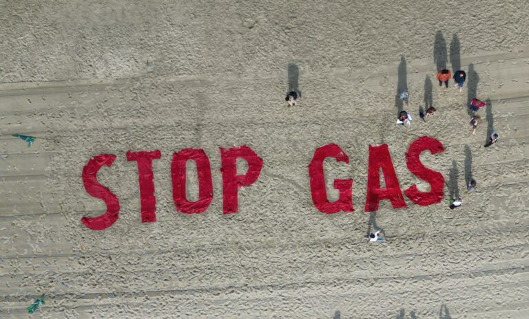 Bei einem Protest auf Borkum im Juli hatten Klimaschutzaktivisten von Fridays for Future ihre Forderung in den Sand geschrieben. (Archivbild) Foto: Lars Penning/dpa